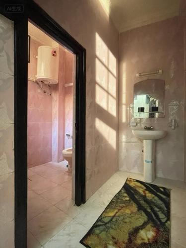 a bathroom with a sink and a toilet at Your new comfortable home with us in Laayoune