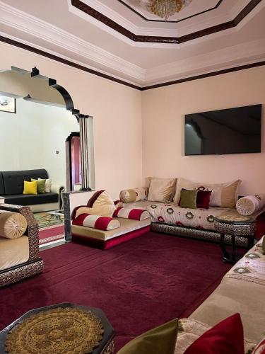 a living room with two couches and a mirror at Your new comfortable home with us in Laayoune