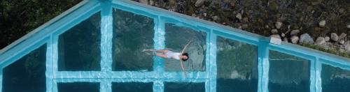 a man in a swimming pool in the water at Barthe Holidays I Apartamento moderno en Arinsal 6PAX a pie de pistas I Balcón con vistas y parking I Riu in Arinsal