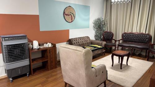 a living room with a couch and a chair at ROFY VIP Apartment in Cairo