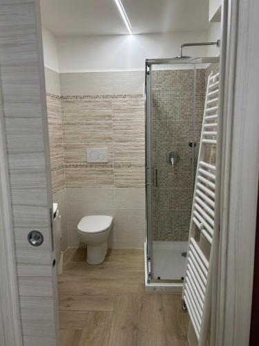 a bathroom with a toilet and a glass shower at Casa Vacanze La Valle in San Donato Val di Comino