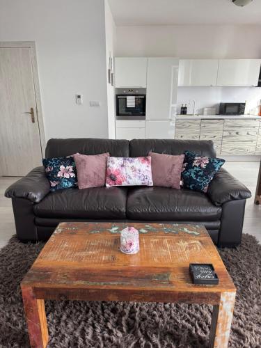 a living room with a leather couch and a coffee table at Beautiful apartment in the city center,with full amenities in Poprad