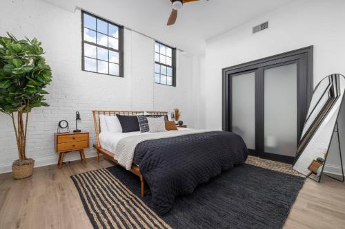 a bedroom with a bed and a plant in it at Stay in heart of Johnson City * Urban Loft * in Johnson City