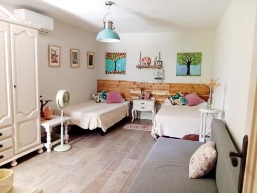 a room with two beds and a desk and a bed at Caminito del Rey Carratraca in Sierra Las Aguas in Malaga