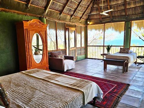 a bedroom with a bed and a mirror in a room at Casa Maria en La Manzanilla in La Manzanilla