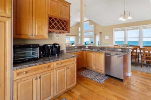 a kitchen with wooden cabinets and a counter top at 8045 - Mirlo Hi in Rodanthe