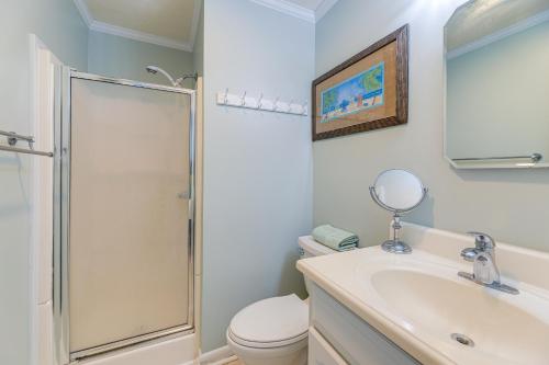 a bathroom with a shower and a toilet and a sink at Steps to Sand! Condo with 2 Pools in Atlantic Beach in Atlantic Beach