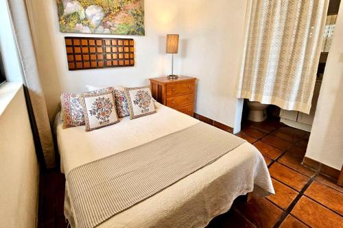 a bedroom with a bed with pillows on it at Casa Maria en La Manzanilla in La Manzanilla