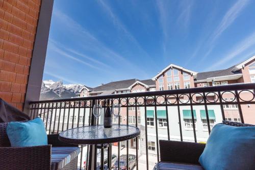 a balcony with a table and a view of the mountains at Westwinds - Funky Basecamp in the Rockies in Canmore