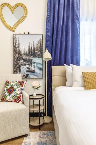 a bedroom with a bed and a couch and a chair at Westwinds - Funky Basecamp in the Rockies in Canmore