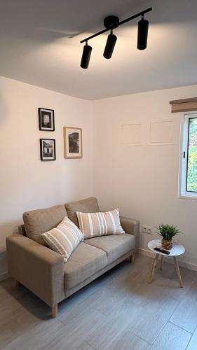 a living room with a couch and a table at Old Aqueduct Village 1 - Guesthouse - Madeira in Serra de Água