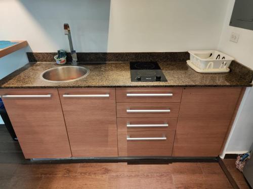 a kitchen with a sink and a counter top at Palma Real Beach Club in Playa Blanca
