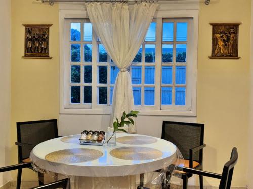 a dining room with a table and a window at Pavilhão Egípcio in Curitiba
