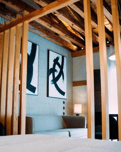 a room with a bed and two pictures on the wall at Hotel Spa Los Mercaderes in Talavera de la Reina