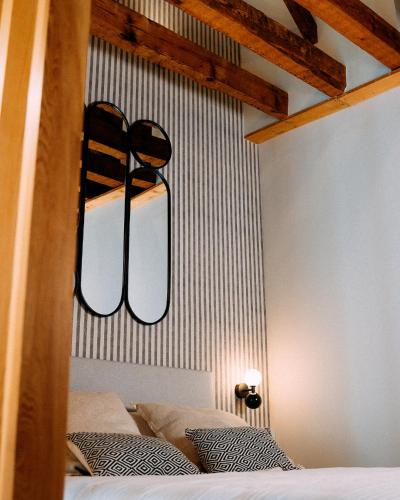 a bedroom with a bed with a light above it at Hotel Spa Los Mercaderes in Talavera de la Reina
