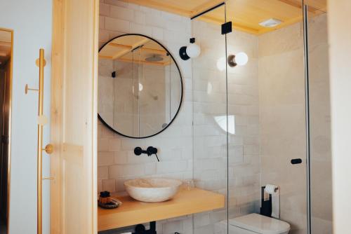 a bathroom with a sink and a glass shower at Hotel Spa Los Mercaderes in Talavera de la Reina