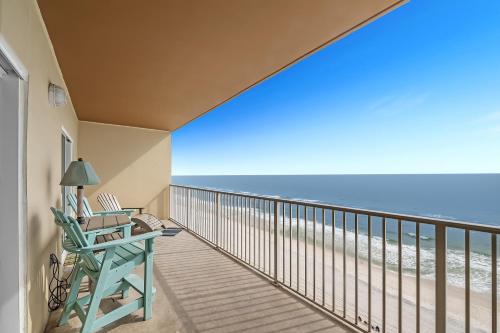 a balcony with a desk and a chair and the beach at Crystal Shores West Unit 705 in Gulf Shores
