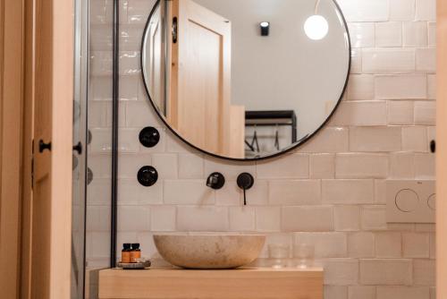 a bathroom with a sink and a mirror at Hotel Spa Los Mercaderes in Talavera de la Reina