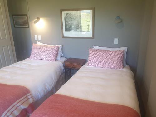 two beds sitting next to each other in a room at The Bluffs Villa in Queenstown