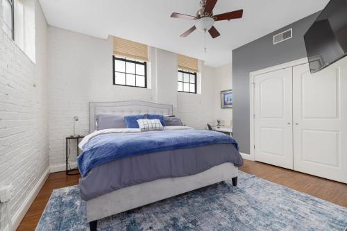 a bedroom with a bed and a ceiling fan at New Downtown JC Loft! in Johnson City