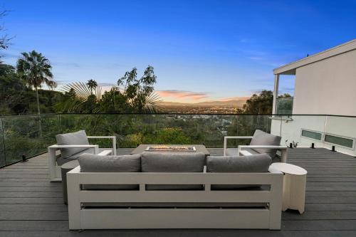 a patio with a couch and chairs on a deck at Hollywood Hills Retreat - Next to Universal Studios in Los Angeles