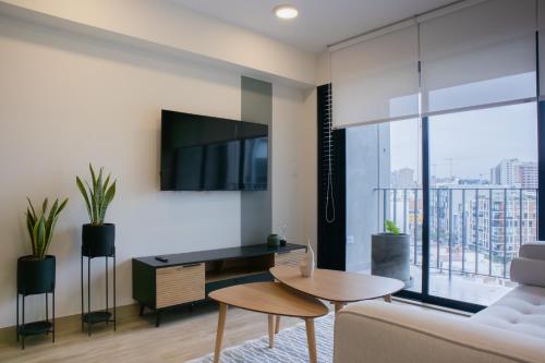 a living room with a couch and a table at Pod by Wynwood House in Lima