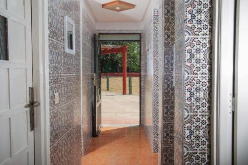 a hallway with tiled walls and a door at Paradise Farm 20 min from Rabat in Sale