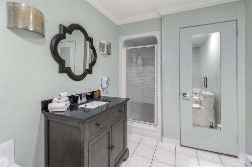 a bathroom with a sink and a mirror on the wall at Dannys Suites, SureStay Collection by Best Western in Beresford