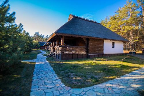 a log cabin with a stone path in front of it at Ресторан Отель Гуляй Поле in Novomoskovsʼk