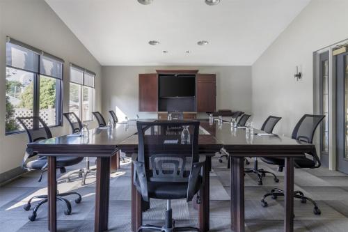 a conference room with a long table and chairs at Dannys Suites, SureStay Collection by Best Western in Beresford