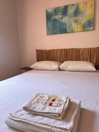 a bed with a tray with a towel on it at Pousada Meu Lugar in Jericoacoara