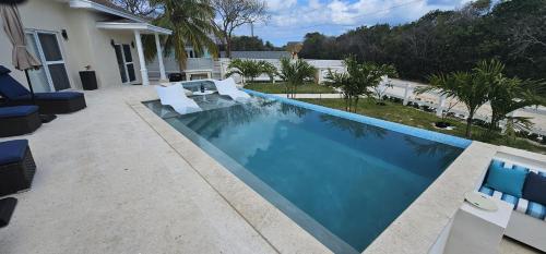 a swimming pool in a yard next to a house at Porpoise Paradise Luxury Villa 