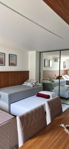 a bedroom with two beds and a couch at Unity 415 in João Pessoa