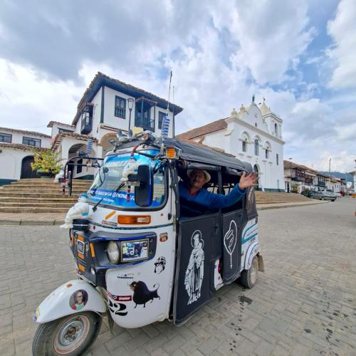 a man is standing in the back of a small car at Cabaña Lomitas Sotaquira in Sotaquirá