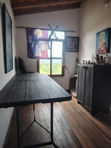 a dining room with a table and a window at Cabaña Lomitas Sotaquira in Sotaquirá