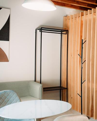a room with a table and a mirror at Hotel Spa Los Mercaderes in Talavera de la Reina