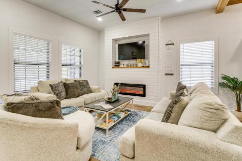 a living room with two couches and a fireplace at 1 Mi to Dtwn Brenham! The Bell and Bloom Cottage in Brenham