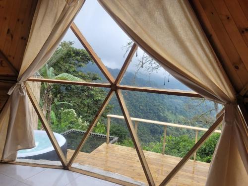 a room with a view from a tent with a window at hotel y restaurante mirador aires de la sierra, minca in Minca