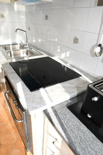 a kitchen counter with a sink and a stove at Sorrento Soul in Sorrento