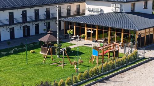 an outdoor playground in front of a building at HAPPY81 noclegi - 3,5km Energylandia in Zator
