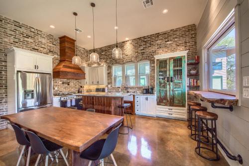 a kitchen with a wooden table and a brick wall at RR 7134 River Repose in Canyon Lake