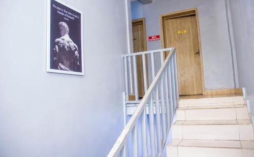 a stairway with a poster on the side of a building at Morada Hotels Ltd in Lagos