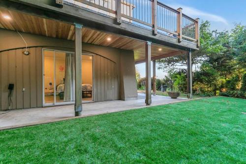 a house with a balcony and a yard at Modern Spacious Ocean-view Suite with Private Ent in West Vancouver
