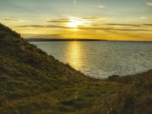 a sunset over a large body of water at 6 person holiday home in Struer-By Traum in Struer