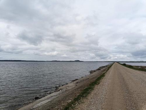 a dirt road next to a large body of water at Panoramic View Fisherman's House - By Traum Ferienwohnungen in Vesløs