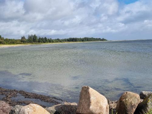 a large body of water with rocks on the shore at Panoramic View Fisherman's House - By Traum Ferienwohnungen in Vesløs