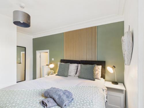 a bedroom with a bed with towels on it at Stylish Maisonette with Hot Tub in Brighton & Hove