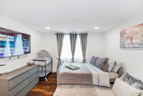 a bedroom with a bed and a couch and a tv at Beautiful renovated house in Downtown Napa 4BD 2BA in Napa
