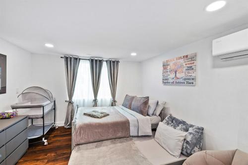 a bedroom with a bed and a crib at Beautiful renovated house in Downtown Napa 4BD 2BA in Napa