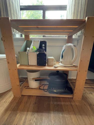 a wooden shelf with dishes and other items on it at Ophelias Casa in Vancouver